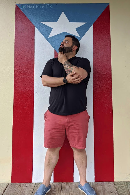 Nelson Colon in front of Puerto Rican flag at Naranjito